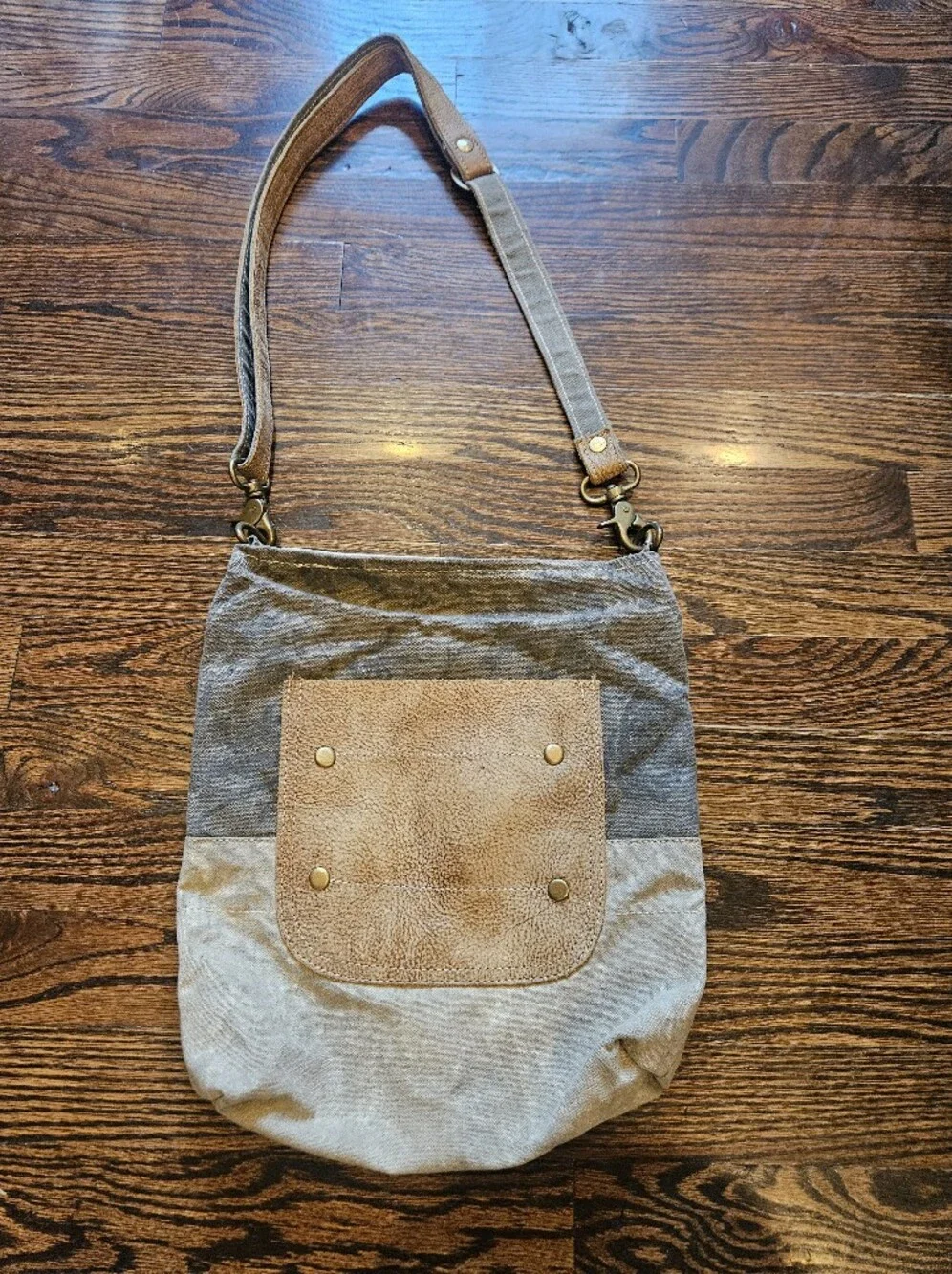 Myra Bag features a upcycled canvas body with a distressed leather pocket